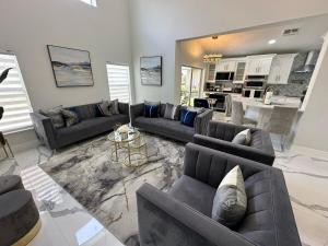 a large living room with couches and a kitchen at Beautifully Remodeled Home - Southen Dunes Golf Course Views in Haines City