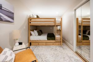 a bedroom with two bunk beds and a mirror at Modern Luxury 3 BR Near Presidio & GG Park in San Francisco