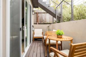 an outdoor patio with a wooden table and chairs at Modern Luxury 3 BR Near Presidio & GG Park in San Francisco +19 photos