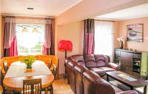 a living room with a couch and a table at Nice Home In Nowe Warpno With Kitchen in Nowe Warpno