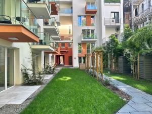 an apartment building with a lawn in front of it at B40 Green ApartRooms in Budapest