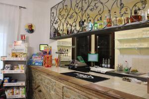 a counter in a store with a cash register at La Locanda del Brigante in Farindola +32 photos