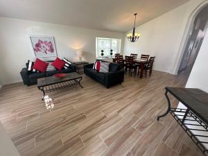 a living room with a couch and a table at Updated Pool Villa - Southern Dunes in Haines City