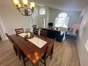 a dining room and living room with a table and chairs at Updated Pool Villa - Southern Dunes in Haines City +17 photos