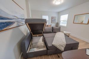 a living room with a couch and a table at #StayInMyDistrict Coos Bay Indigo Cottage in Coos Bay