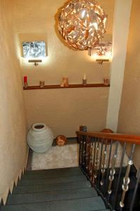 a staircase with a chandelier and a pot on the floor at Agathi in Pramanta