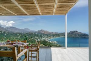 a dining room with a view of the water at New Seaview Villa Minoiko with Private Pool near the Beach in Plakias in Sellía +54 photos