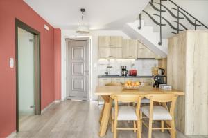 a kitchen with a wooden table and chairs at New Seaview Villa Minoiko with Private Pool near the Beach in Plakias in Sellía