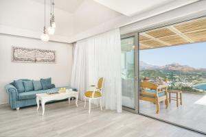 a living room with a blue couch and a table at New seaview villa Venetsianiko with Private Pool & BBQ close to the beach in Sellía
