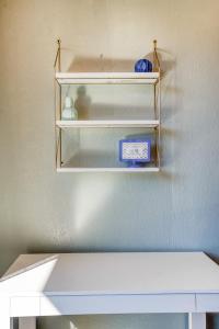 a shelf in a room with some items on it at #StayinMyDistrict Heritage House Suite in Coos Bay