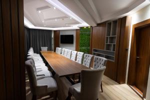 a conference room with a wooden table and chairs at Villa EUPHORIA in Ridovo +77 photos