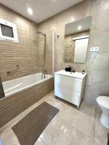 a bathroom with a sink and a tub and a toilet at Cozy apartment - Balcony & Sea View in Fuengirola