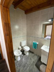 a bathroom with two toilets and a sink at Departamento El Origen-SMA in San Martín de los Andes +3 photos