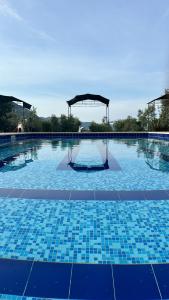 a swimming pool with blue tiles on the ground at La fattoria di Carlotta in Maenza