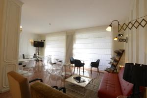 a living room with a couch and tables and chairs at Hotel Tourist in Turin