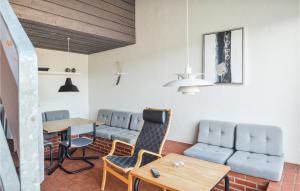 a waiting room with blue chairs and a table at Feriehotal Tranum Klit in Brovst