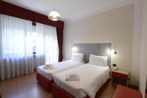 a hotel room with a bed and two lamps at Hotel Tourist in Turin