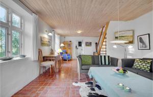 a living room with a couch and a table at Two-Bedroom Holiday Home Thyholm With Sea View 04 in Thyholm