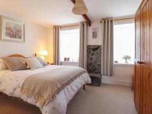 a bedroom with a large bed and two windows at Bodalaw in Trawsfynydd +19 photos