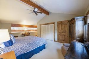 a bedroom with a bed and a desk with a ceiling fan at Rustic Elegance Located near PCM with Hot Tub in Park City