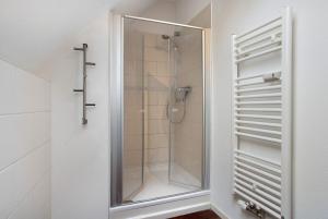 a shower with a glass door in a bathroom at Abendsonne in Ostseebad Koserow +45 photos