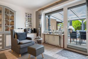 a living room with a chair and a window at Ferienwohnung Heimathafen in Lensahn