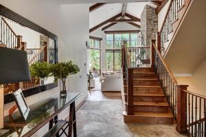 a hallway with a staircase and a living room at 5BR Alpine Luxury Home with Private Hot Tub in Vail