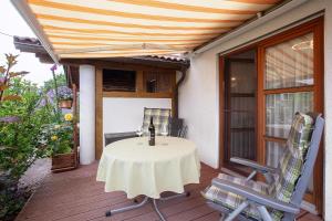 a patio with a table and chairs on a deck at Ferienwohnung Brockmann in Waldshut-Tiengen