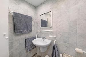 a bathroom with a sink and a mirror at Ferienwohnung 12 im Haus Borkum in Dorum Neufeld +12 photos