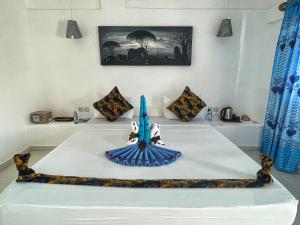 a room with a bed with a figurine on it at AVO Boutique Hotel in Dikoni