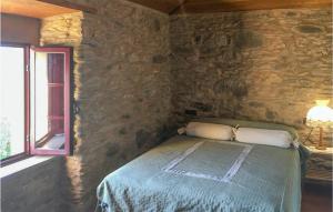 A bed or beds in a room at 3 Bedroom Cozy Home In Ortigueira