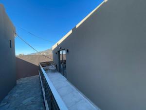 a balcony with a table and chairs on a building at Elafonisi Paradise with Parking, WiFi, - Walking Distance to the Beach in Elafonisi