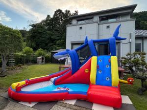 a colorful inflatable bounce house in a yard at MIKOTO HOUSE in Kashū