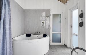 a large white tub in a bathroom with a window at Stunning Home In Ebeltoft With Kitchen in Ebeltoft +24 photos