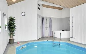 a bathroom with a swimming pool and a bath tub at Stunning Home In Ebeltoft With Kitchen in Ebeltoft