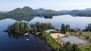 an aerial view of a resort on a lake at Lakefront Mountain View - Resort Loft in Lac-Superieur