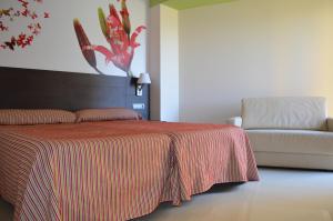 a bedroom with a bed and a dresser at Hotel Porto Calpe in Calpe