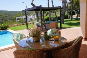 a table with fruit on it next to a pool at Villa Sol de Mallorca in Sol de Mallorca