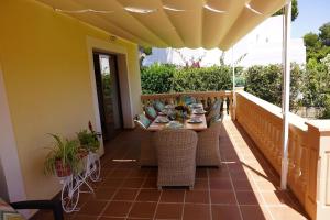 a patio with a table and chairs on a balcony at Villa Sol de Mallorca in Sol de Mallorca