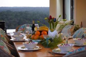 a table with a bunch of food and wine on it at Villa Sol de Mallorca in Sol de Mallorca