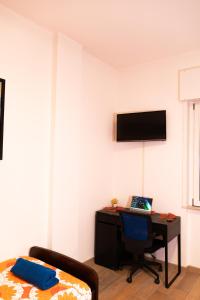 a bedroom with a desk and a computer on a wall at Sunshine Apartment - Salerno in Salerno +13 photos