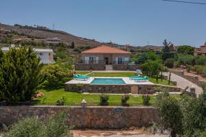 a house with a swimming pool in a yard at Villa Manetti with Private Pool and Garden by Hospi in Kokkíni Khánion