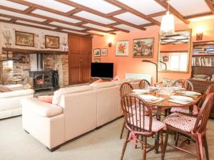 a living room with a couch and a table and chairs at Loanview in Cornhill-on-tweed