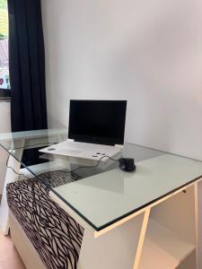 a glass desk with a laptop on top of it at Beach LOFT Tabaiba in Tabaiba