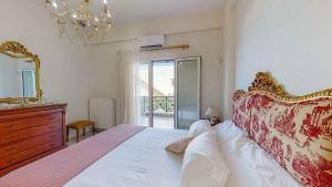 a bedroom with a bed and a dresser and a mirror at Villa Manetti with Private Pool and Garden by Hospi in Kokkíni Khánion +40 photos
