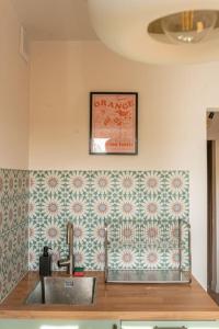 a kitchen with a sink and a picture on the wall at ODPOCZINK 2-pokojowe mieszkanie w centrum in Gdynia +18 photos