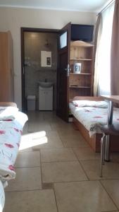 a room with two beds and a bathroom at Pokoje u Ani in Zastań