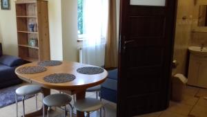 a small table and stools in a living room at Pokoje u Ani in Zastań +10 photos