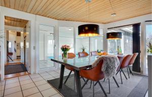 a dining room with a glass table and chairs at Pet Friendly Home In Knebel With Sauna in Skødshoved Strand