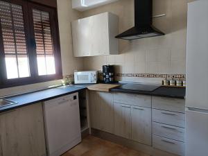 a kitchen with white cabinets and a white microwave at Aracena Centro by Aracena Rural Exp in Aracena